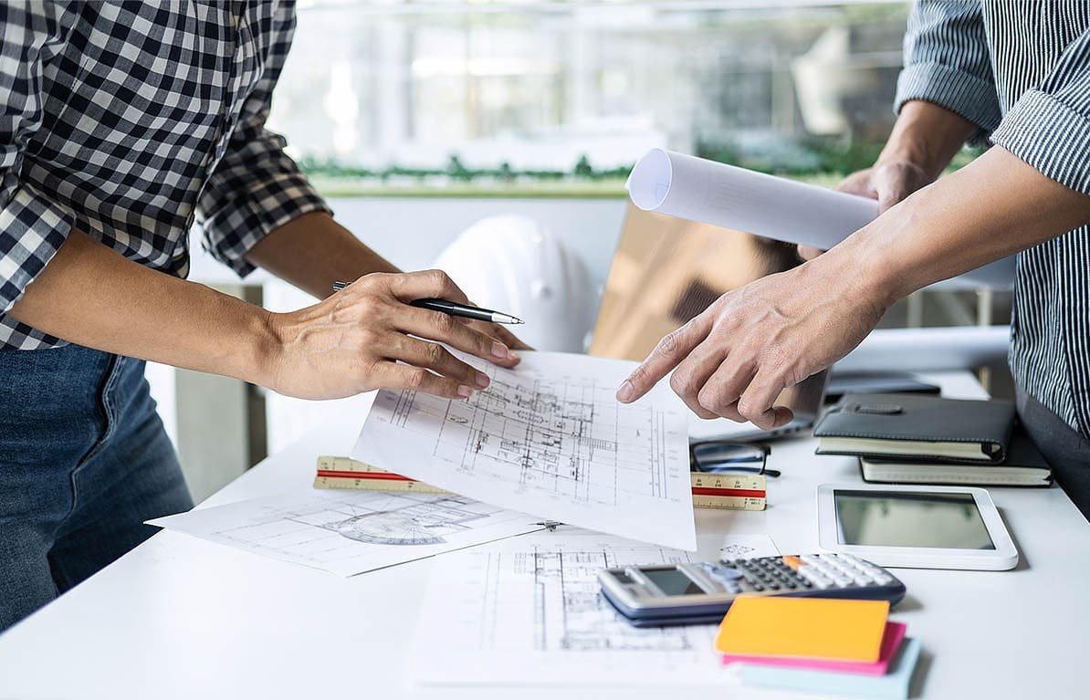 Apex Accuracy Estimating construction takeoff specialists reviewing project plans